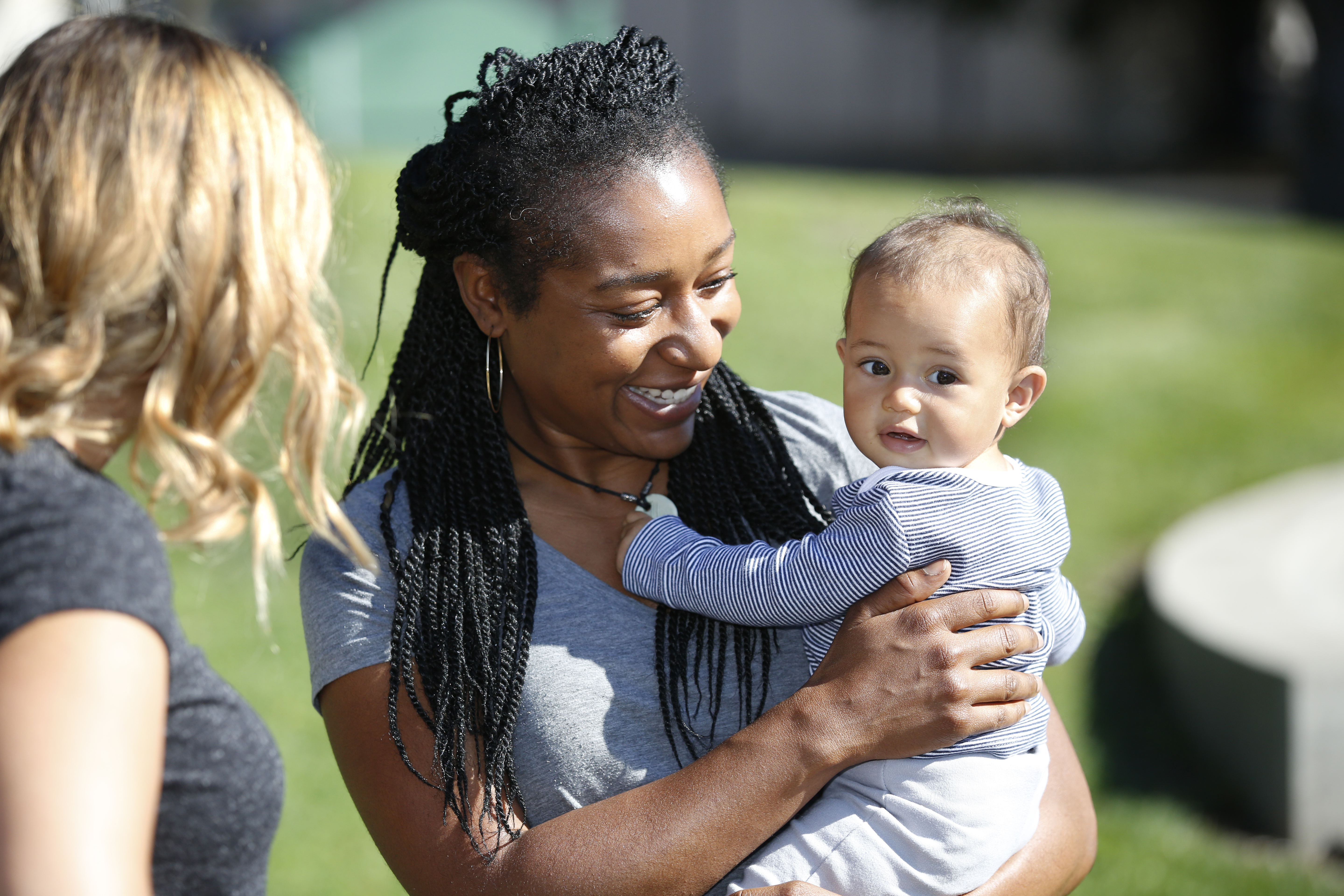 Mother holds her child.